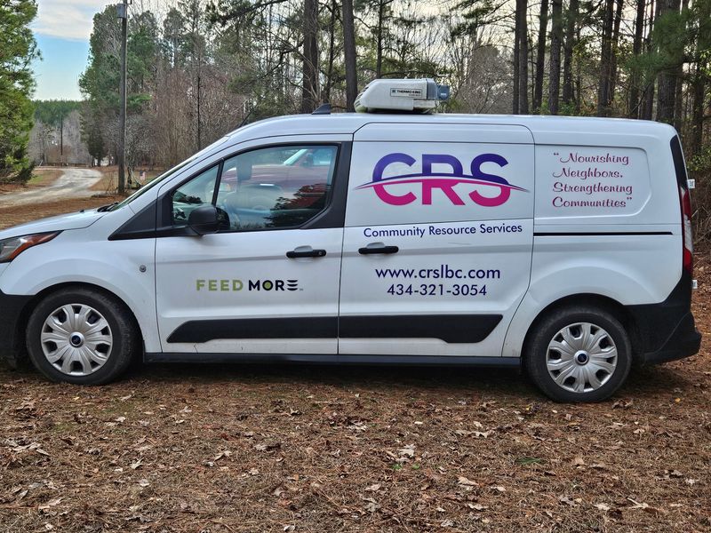 The CRS refrigerated van, marked with the CRS logo, the FeedMore logo and the words Nourishing Neighbors, Strengthening Communities